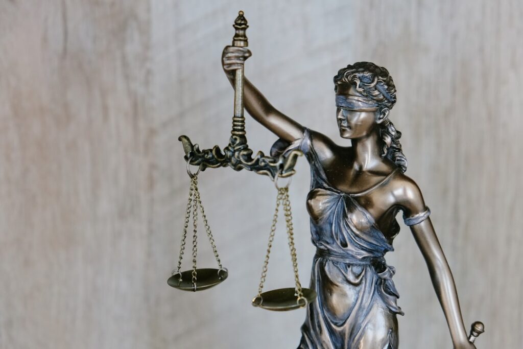 A statue of justice holding scales and sword — illustrating a Singapore outrage-of-modesty case study