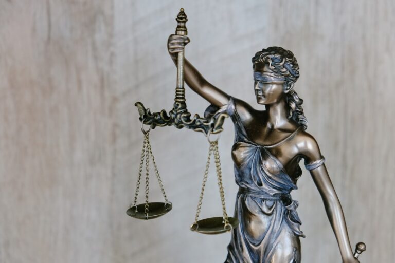 A statue of justice holding scales and sword — illustrating a Singapore outrage-of-modesty case study